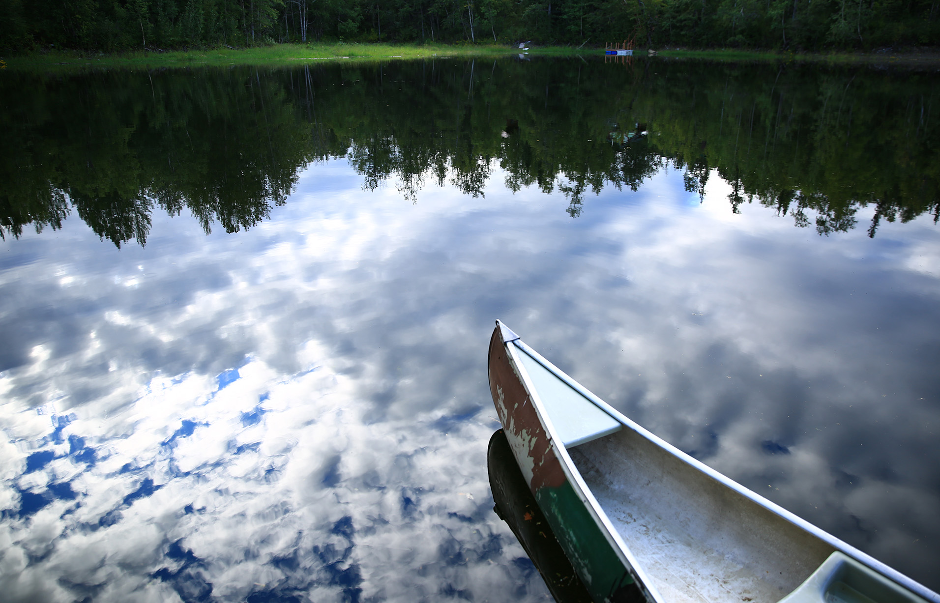 Canoe on perfectly calm lake Canoe in peaceful lake